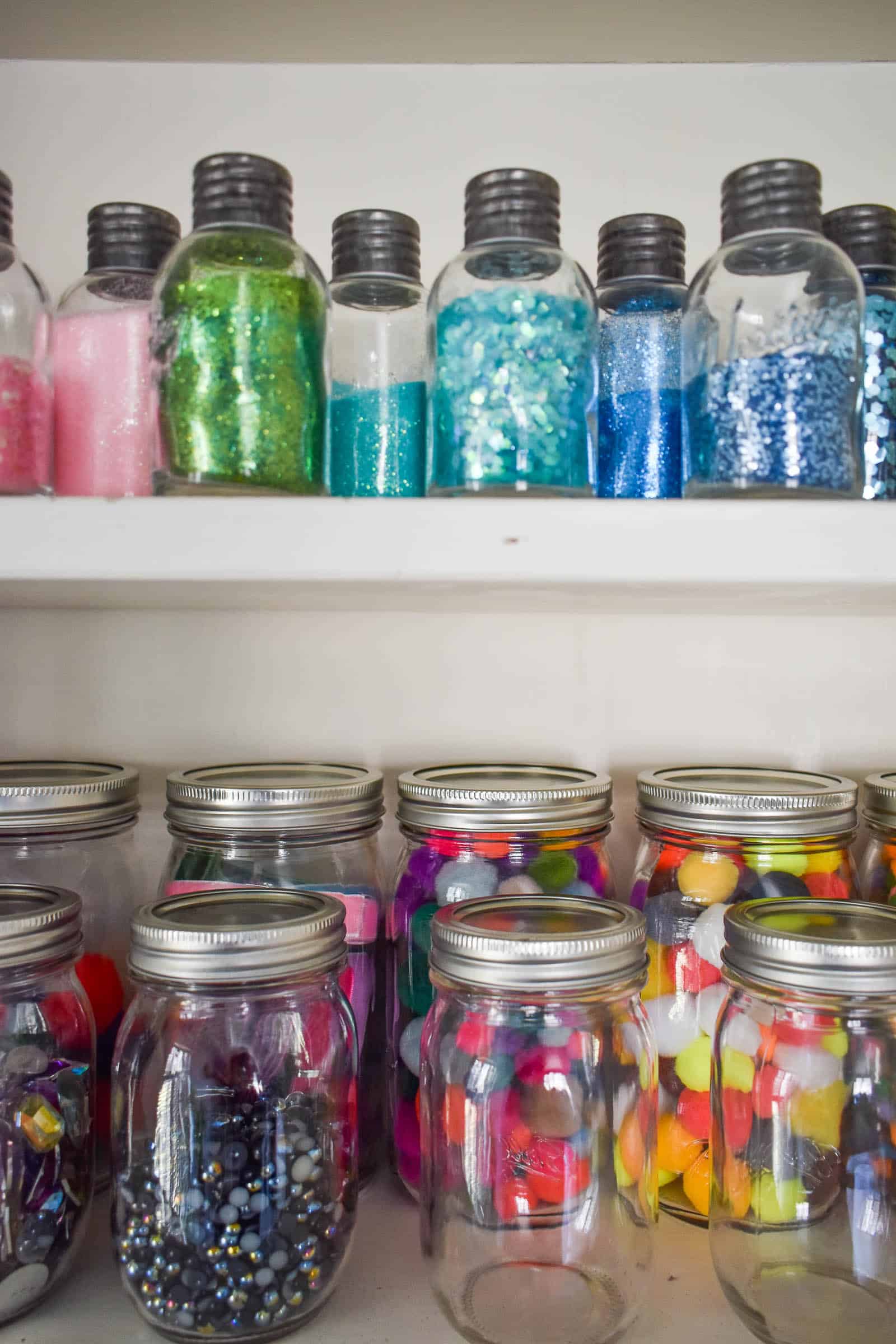 small containers of glitter and pom poms