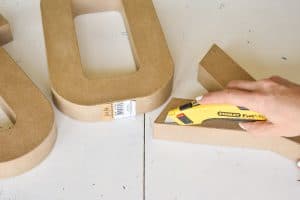use a blade to cut open paper mache letters