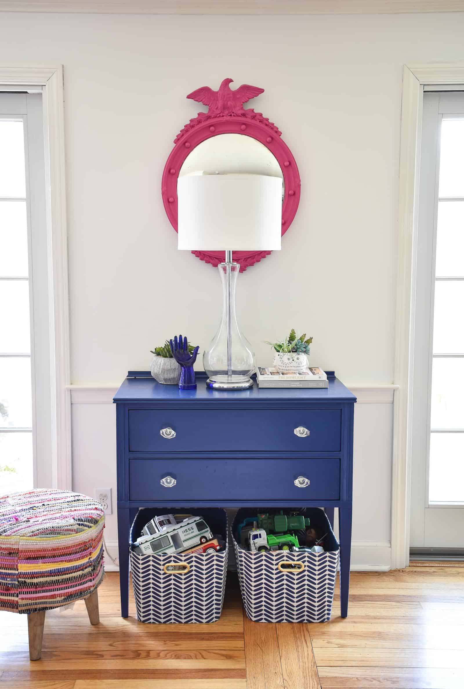 pink mirror hanging over the blue table