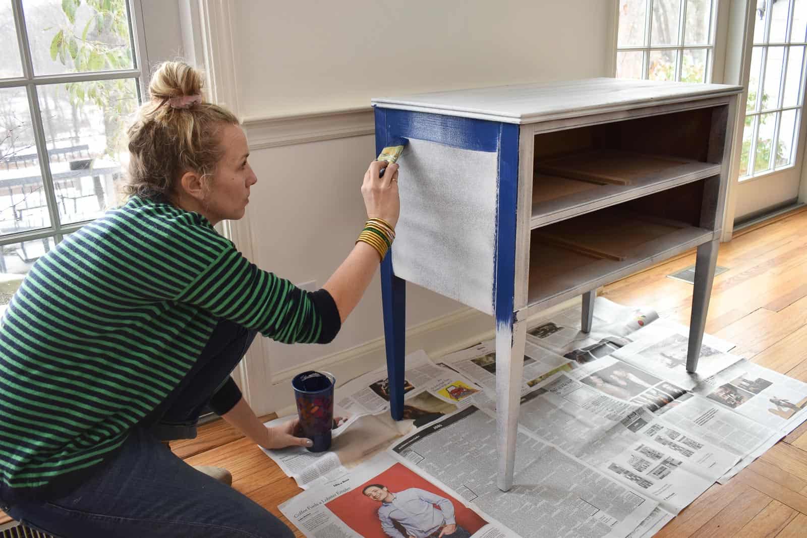 using a brush to paint the table