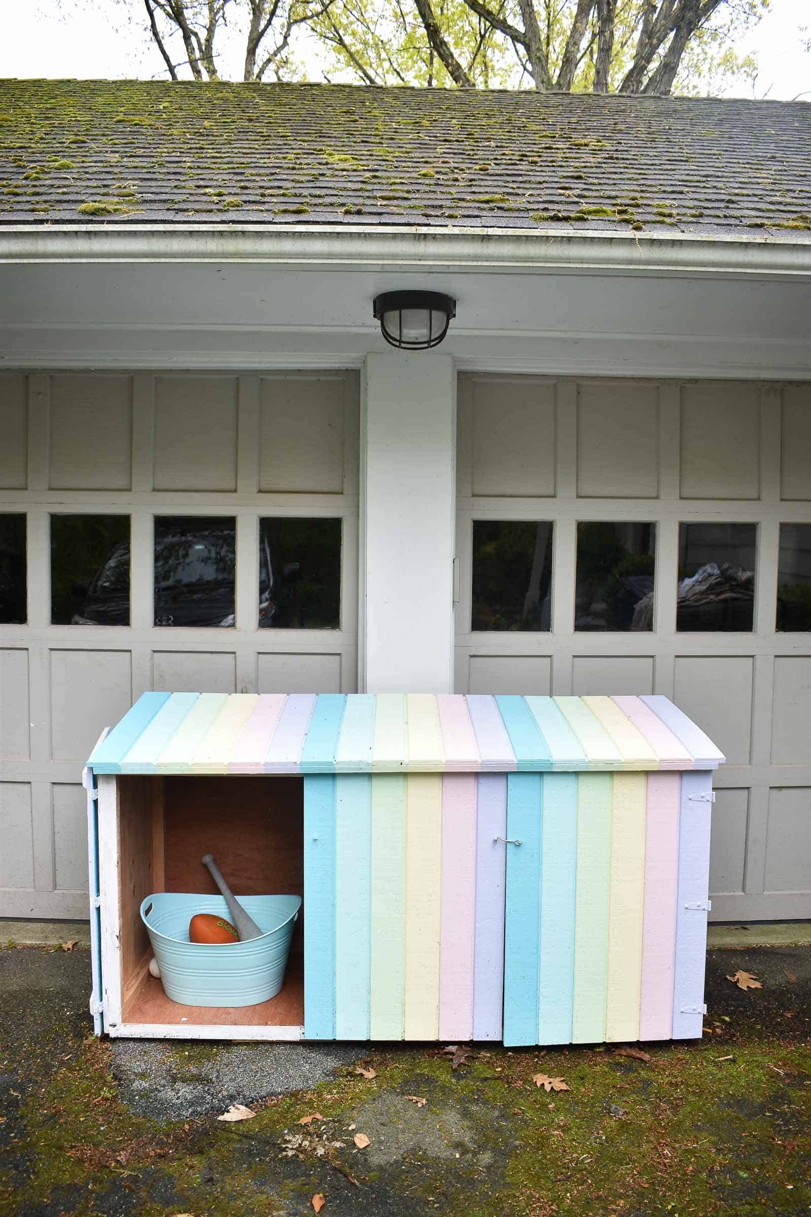 cleaning up toys with a trash can shed