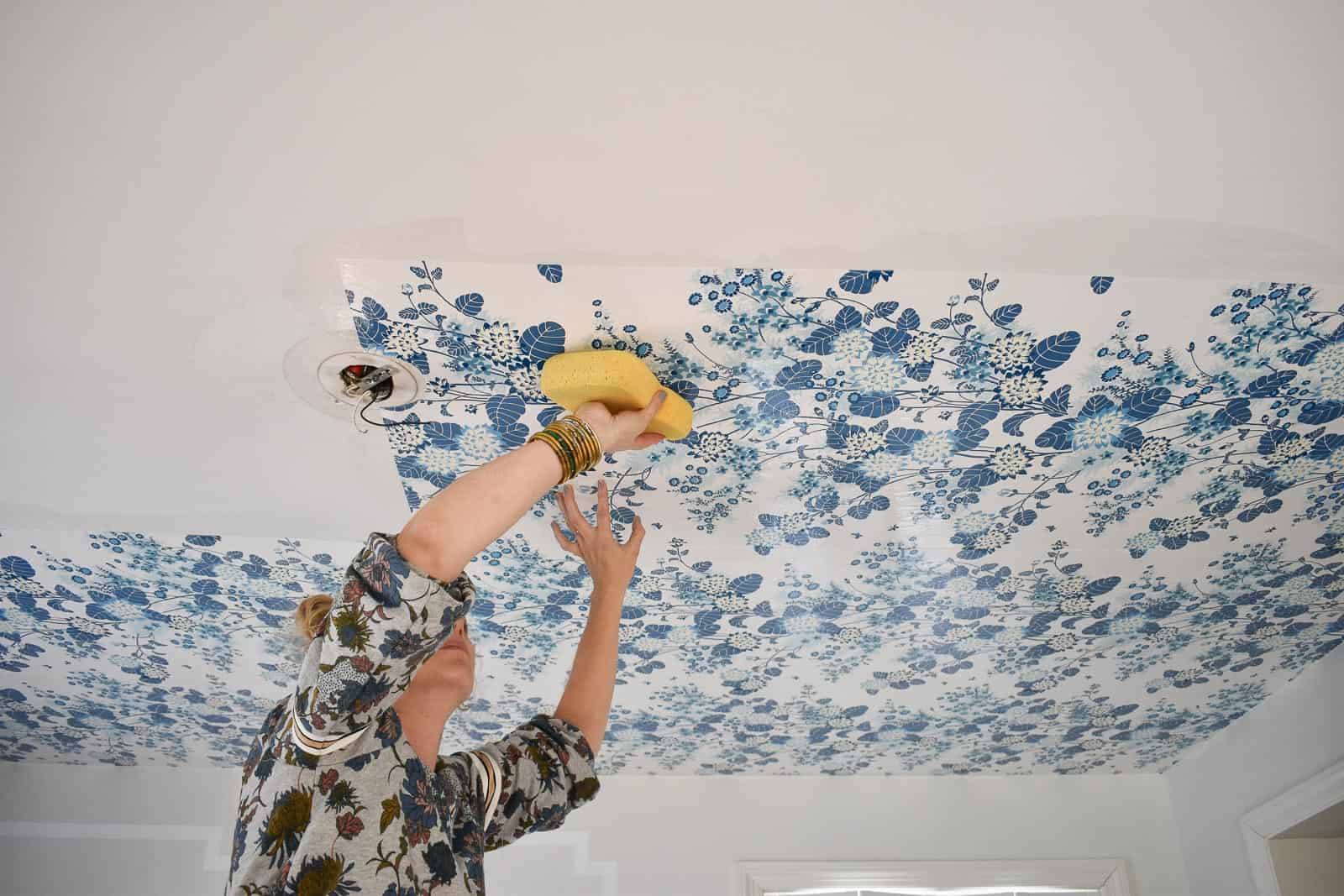 using a sponge adhere the wallpaper