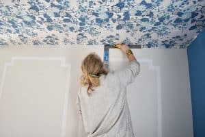 use a straight edge to cut the wallpaper at the corner