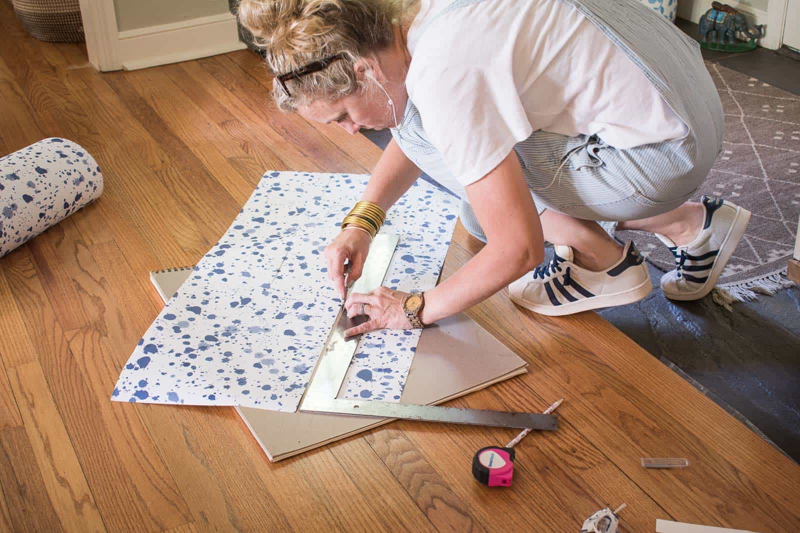 cut the length of wallpaper for each riser