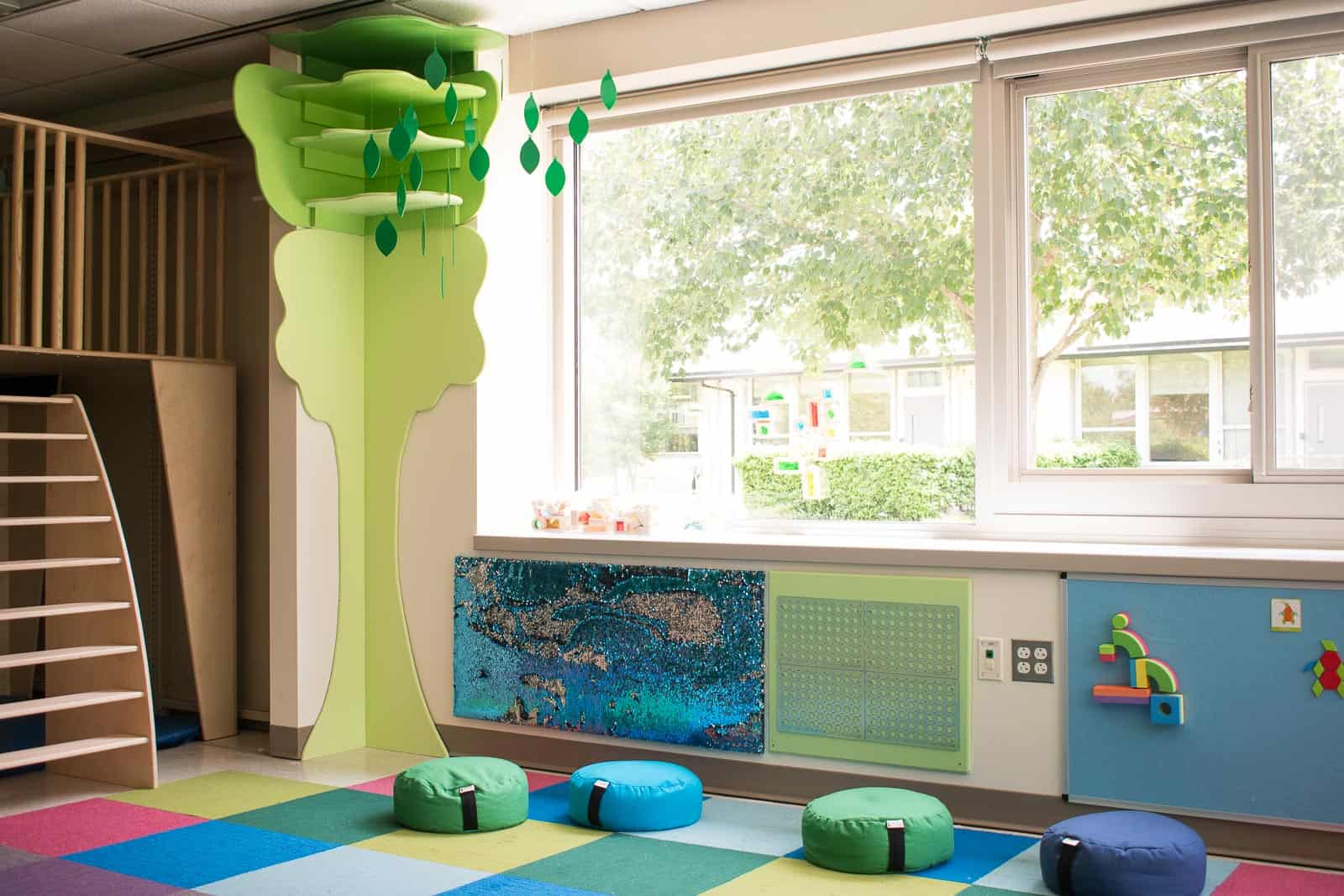 wooden tree in corner of classroom maker space