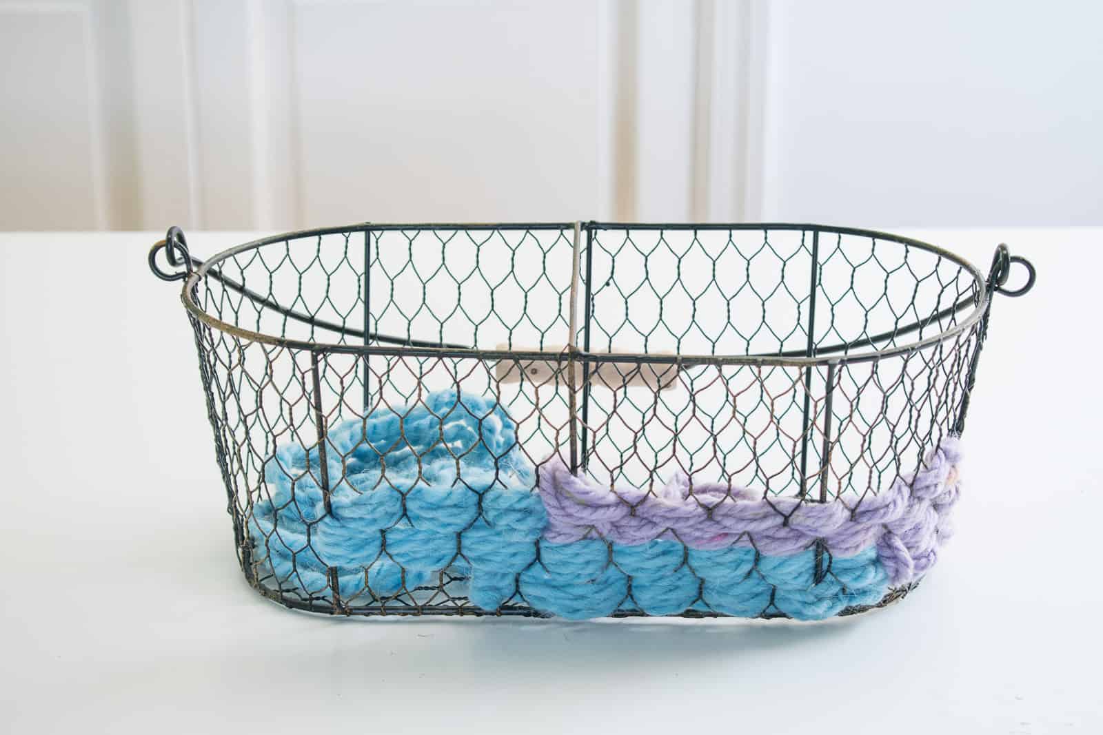 continue weaving the yarn around the basket