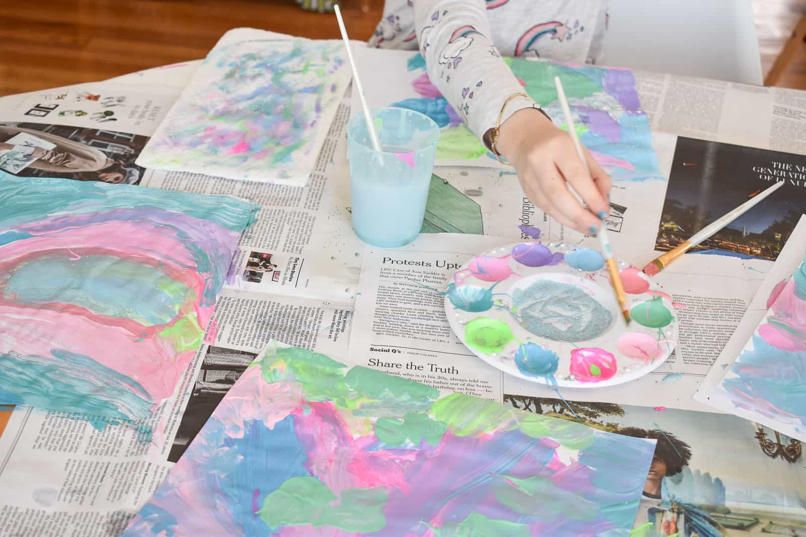 Kids painting with craft paint on paper