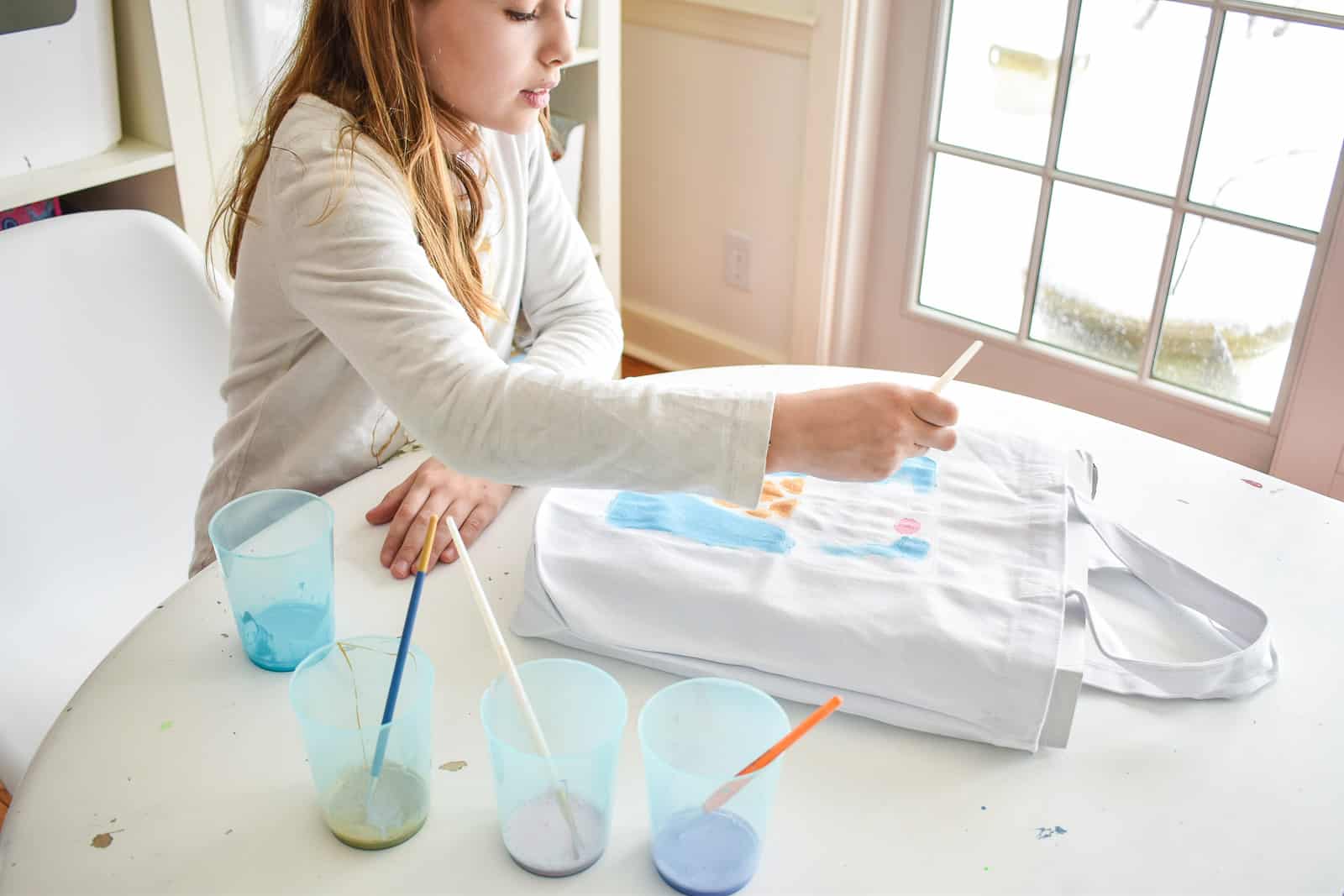 painting the tote bag with glue resist