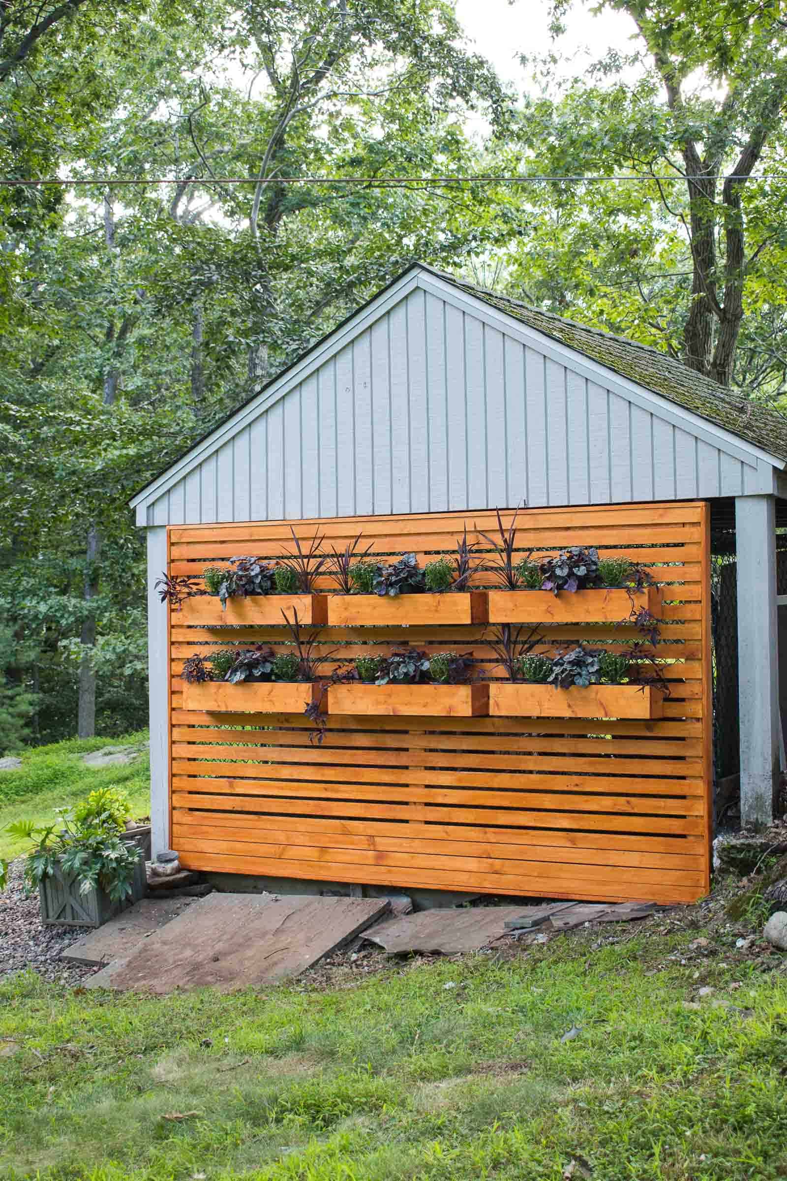 wooden privacy wall to hide a chain link fence