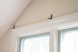 L brackets above window trim