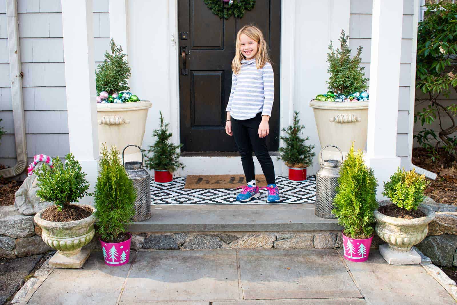 standing on front christmas porch