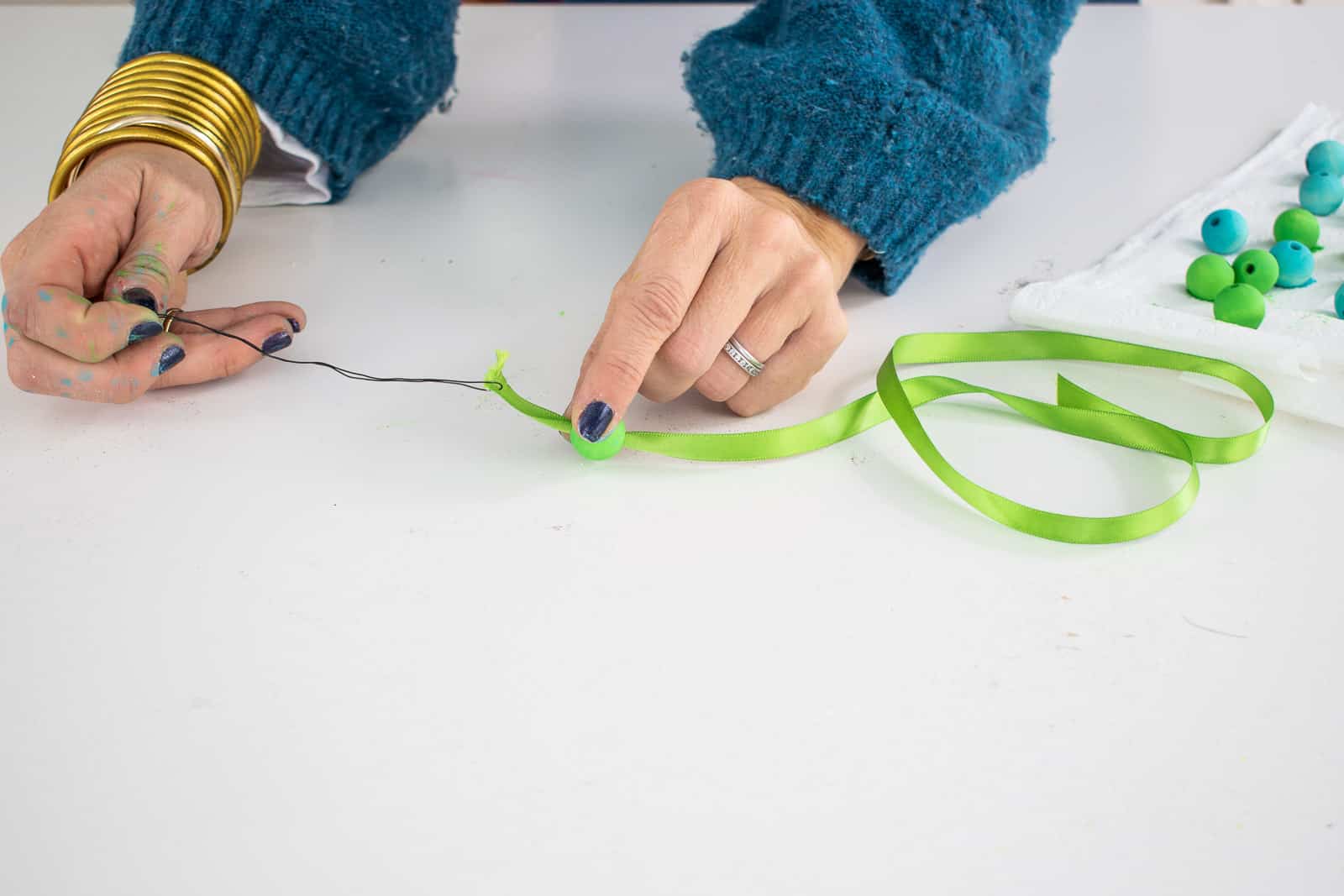 string beads onto ribbon