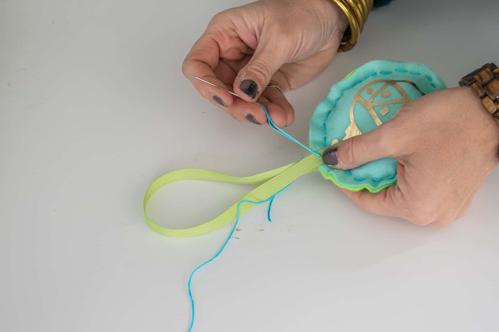 sew ribbon loop onto ornament
