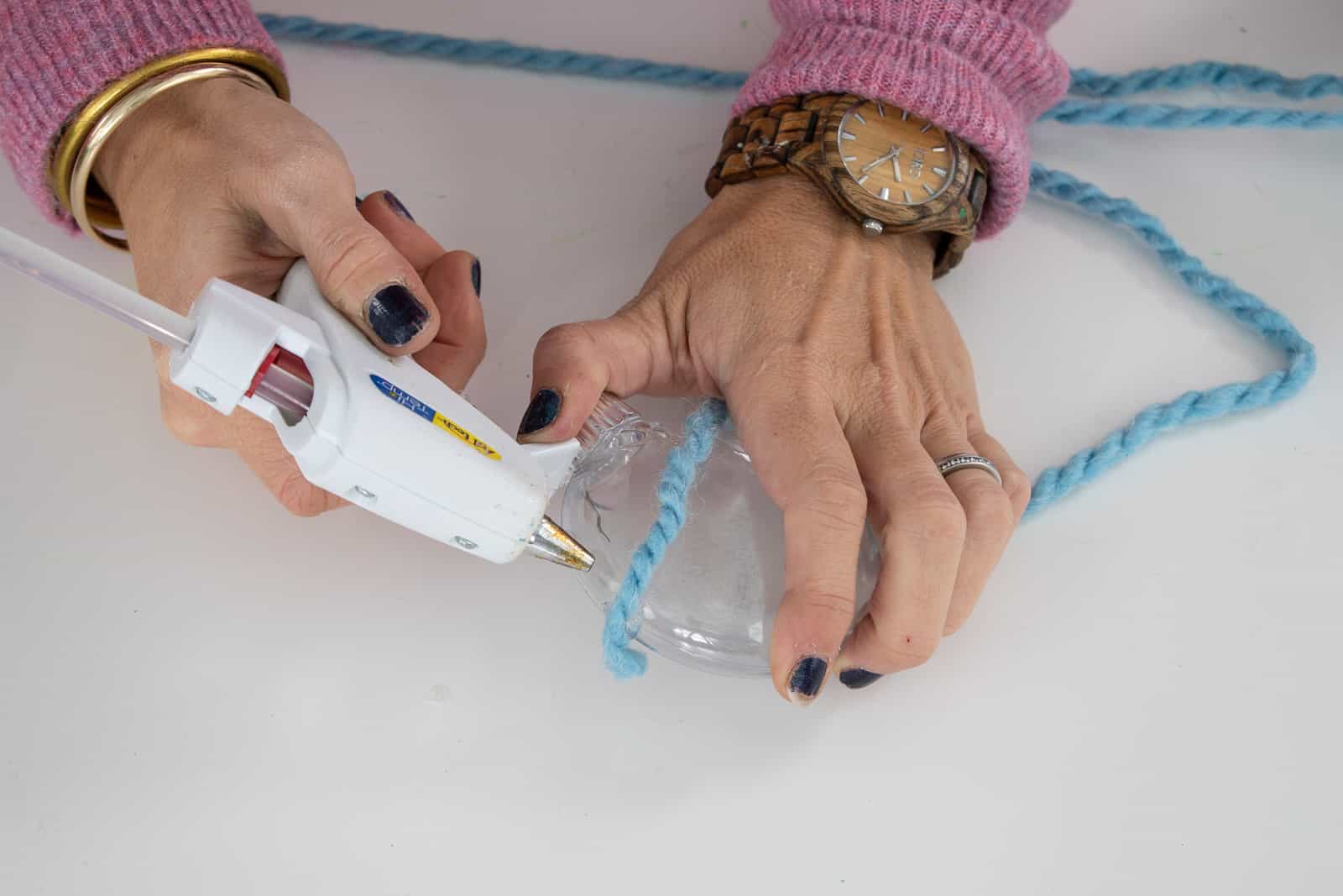 anchor the yarn with a bead of hot glue