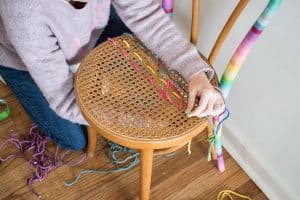 weaving rope through the cane seat