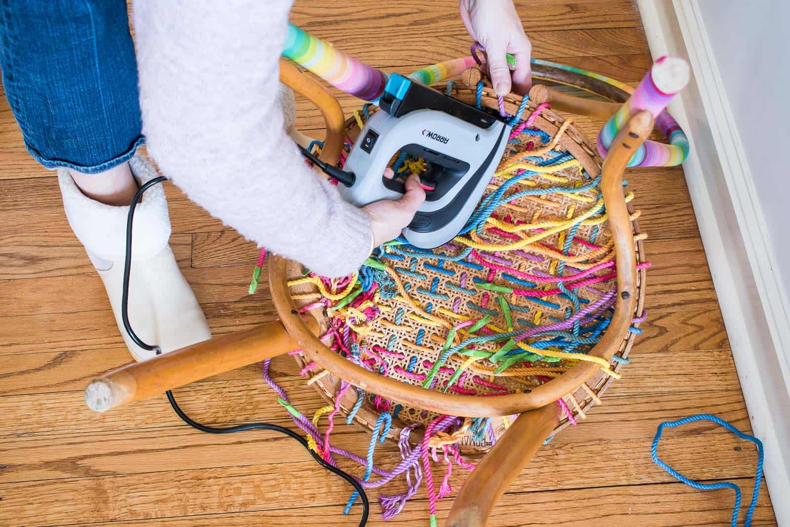 stapling rope in place underneath chair