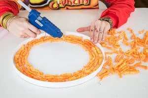 use a hot glue gun to glue cheetos in place