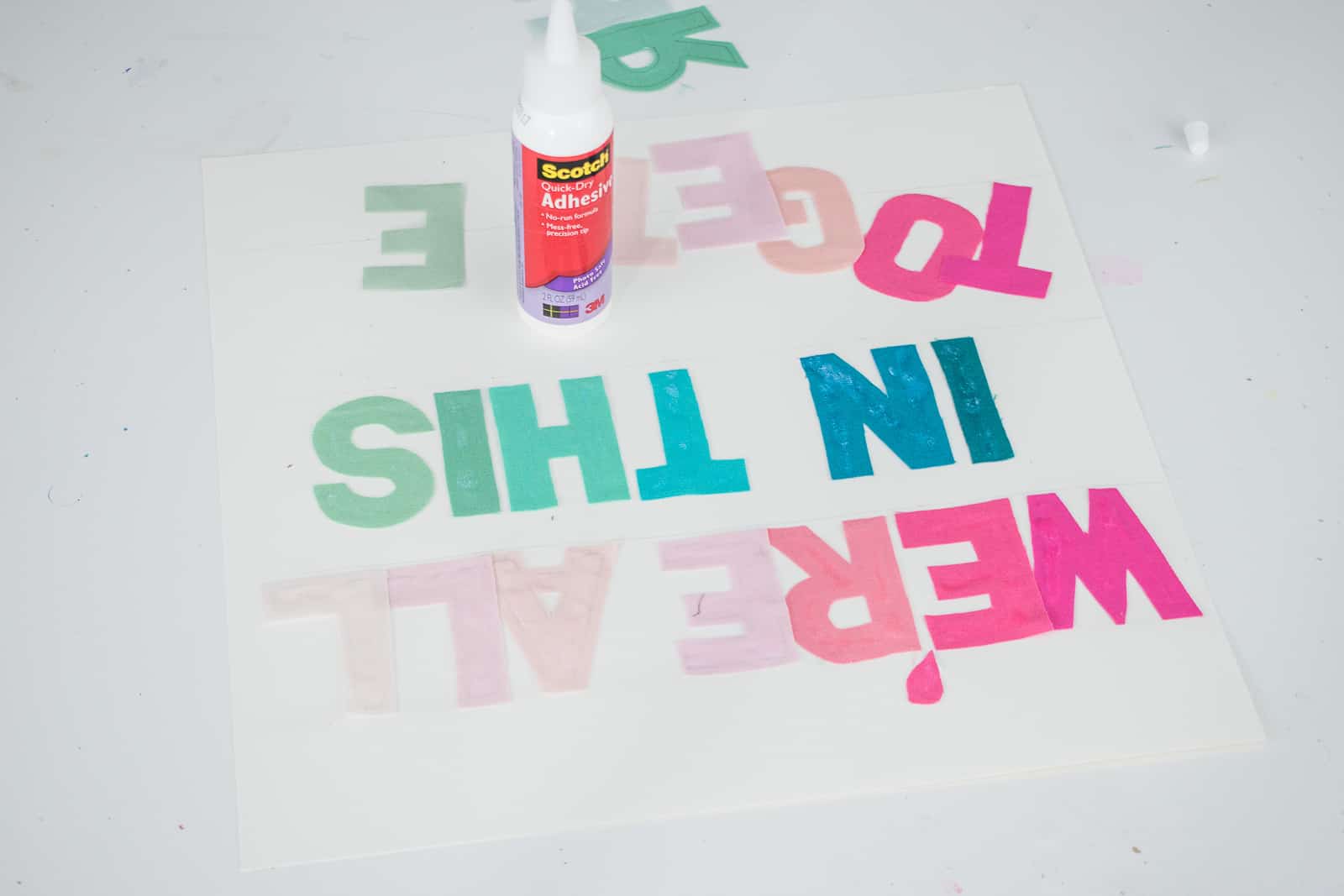 glue fabric letters onto paper