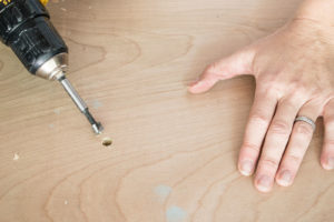 using a forstner bit to drill holes in plywood top