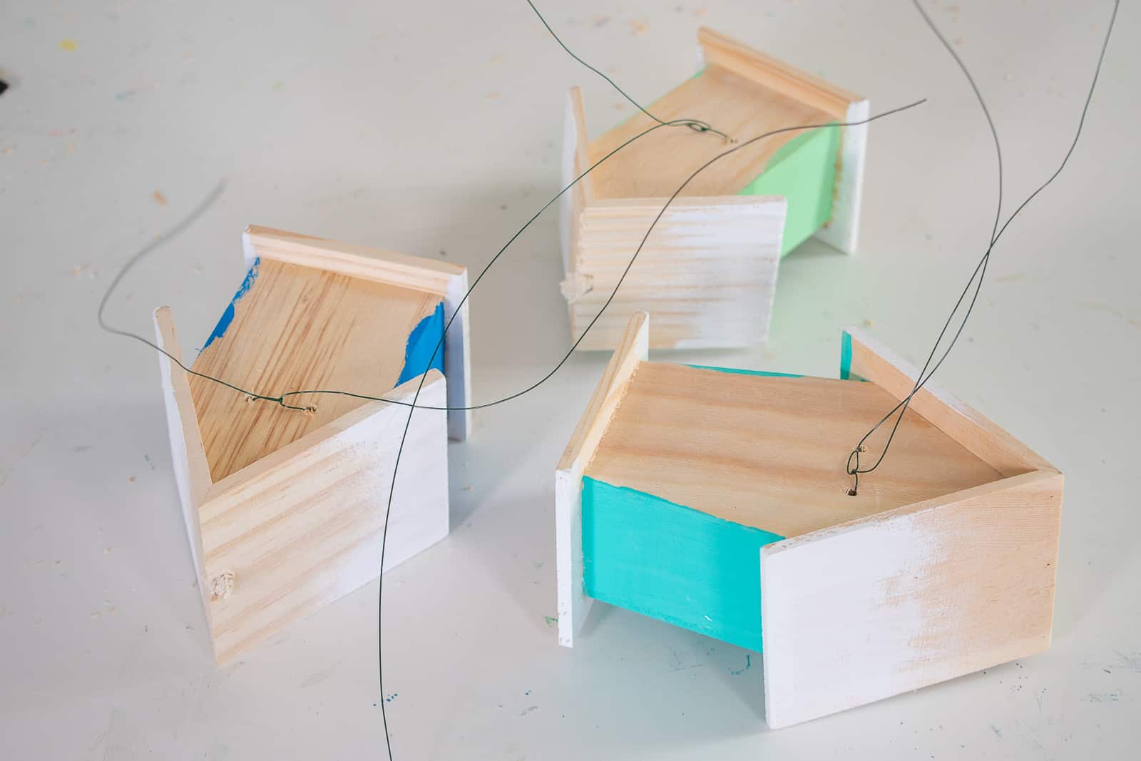 attach wire to the back of the wooden houses