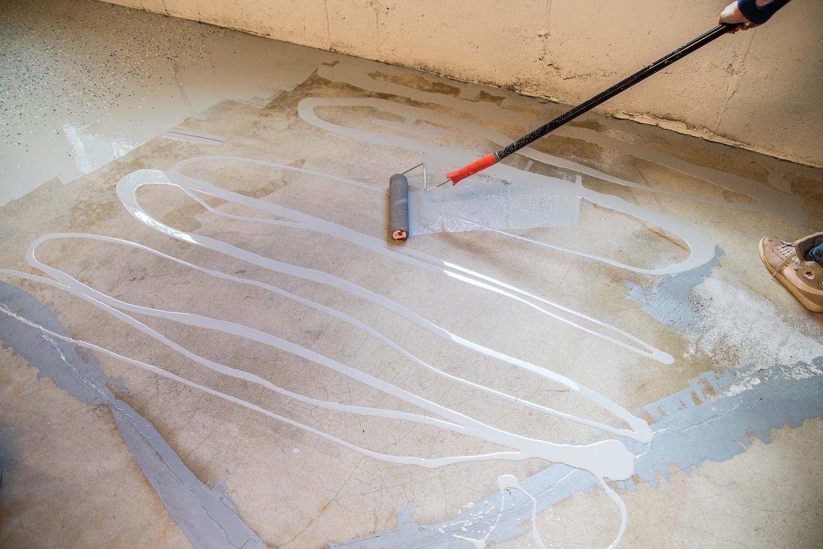 pour the garage floor paint and roll