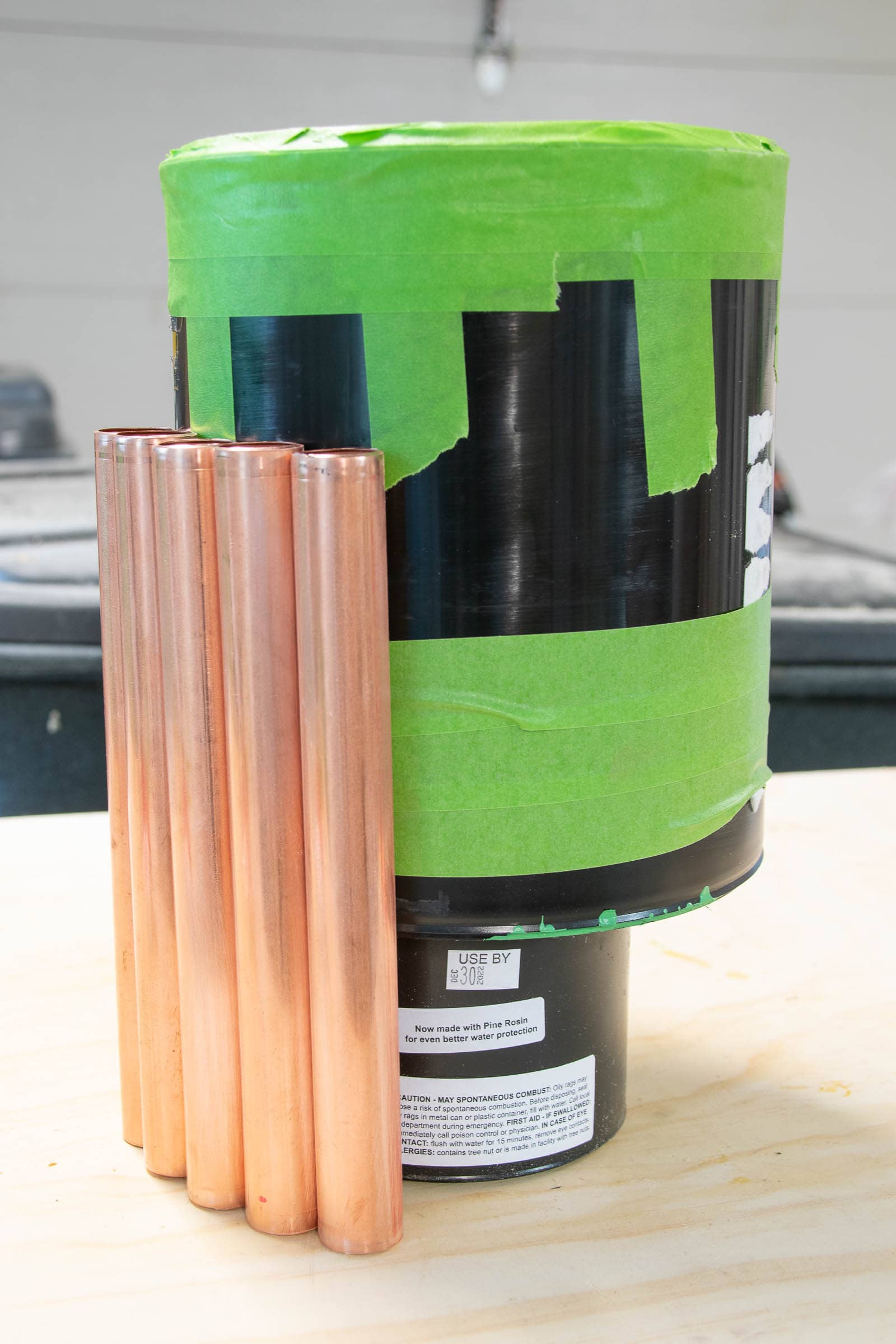sticking copper pipe around paint can