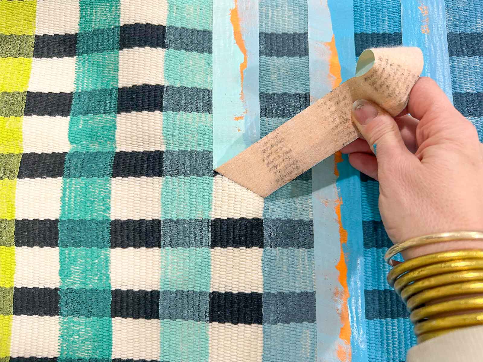 pulling the tape on the striped rug