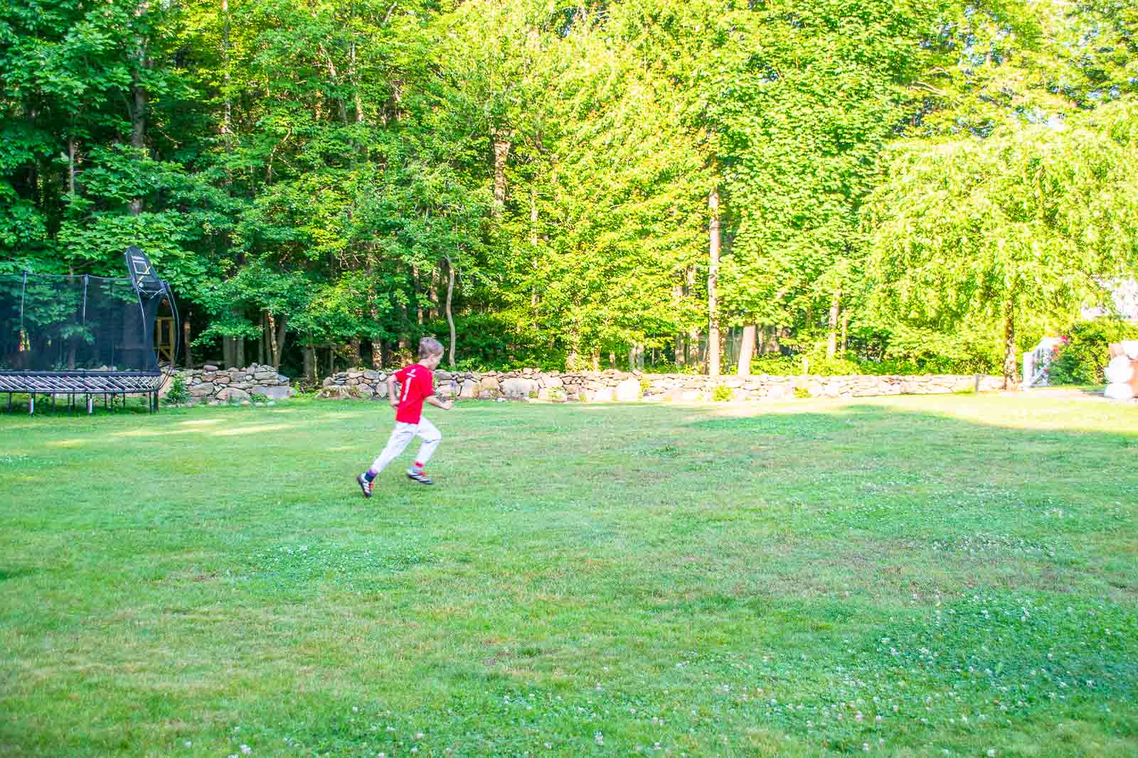 boy running across the lawn