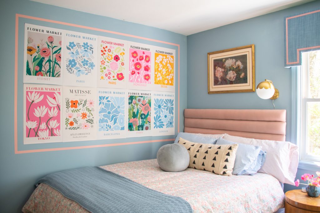 picture of blue bedroom makeover with upholstered pink headboard and decorative flower art