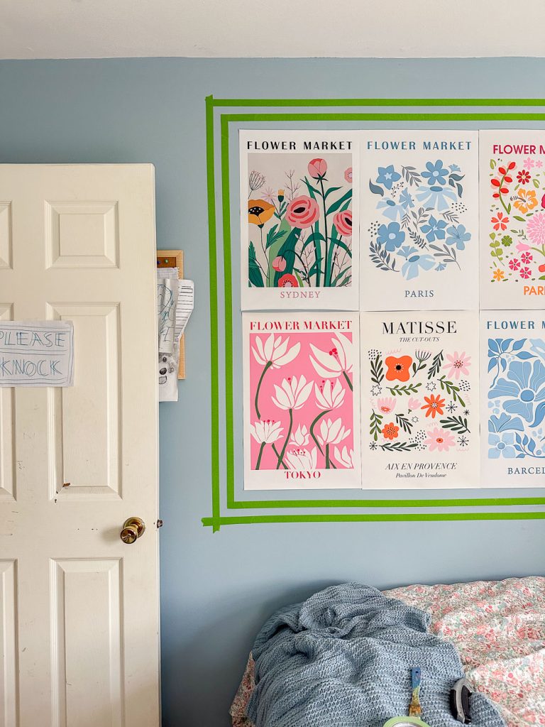 taped off pink frame for posters in girls bedroom