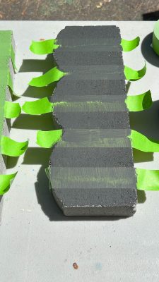 paint the taped pattern on pavers