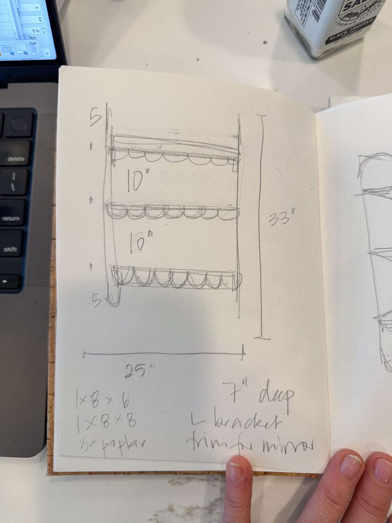 Sketch of a three-tier wall shelf with scalloped edges, measuring 33" tall, 25" wide, and 7" deep. Labeled details include 10" spacing between shelves and construction notes. Part of a notebook, next to a laptop and beverage.